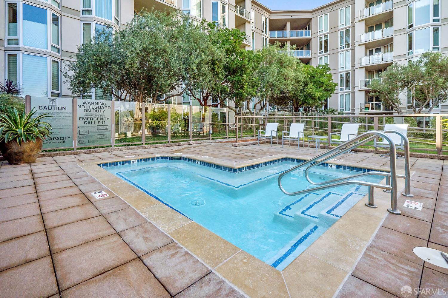 88 King Street, Unit 513 San Francisco, CA 94107 - Photo 27 of 41 a view of a swimming pool with a lounge chairs