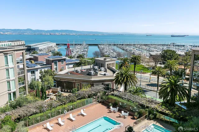 a large room with a table chairs and a chandelier