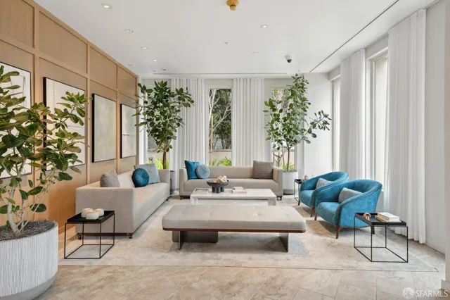 a view of living room filled with furniture and a potted plant