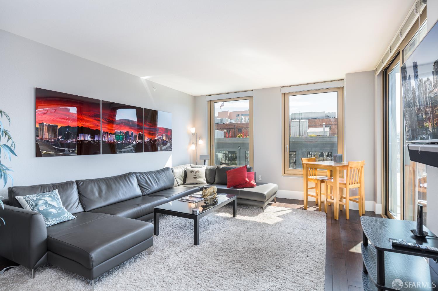 88 King Street, Unit 513 San Francisco, CA 94107 - Photo 6 of 41 a living room with furniture and a flat screen tv