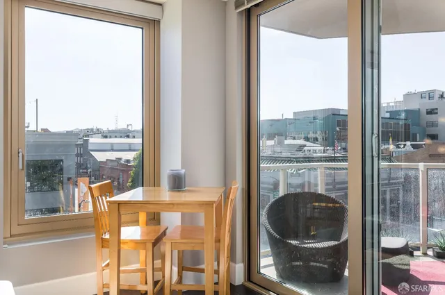 a living room with a fireplace and a floor to ceiling window