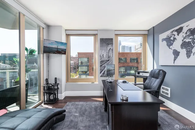 a living room with furniture and large windows