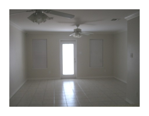 13969 Ports O Call Drive, Unit B Corpus Christi, TX 78418 - Photo 3 of 5 a view of an empty room with wooden floor and a window