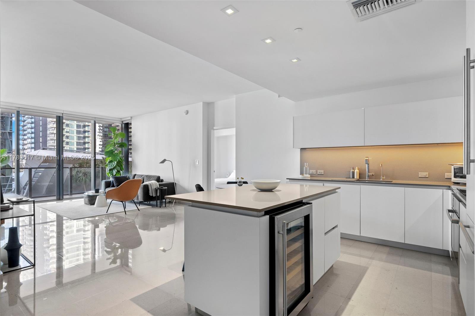 88 Southwest 7th Street, Unit 809 Miami, FL 33130 - Photo 19 of 45 a kitchen with a sink and white cabinets