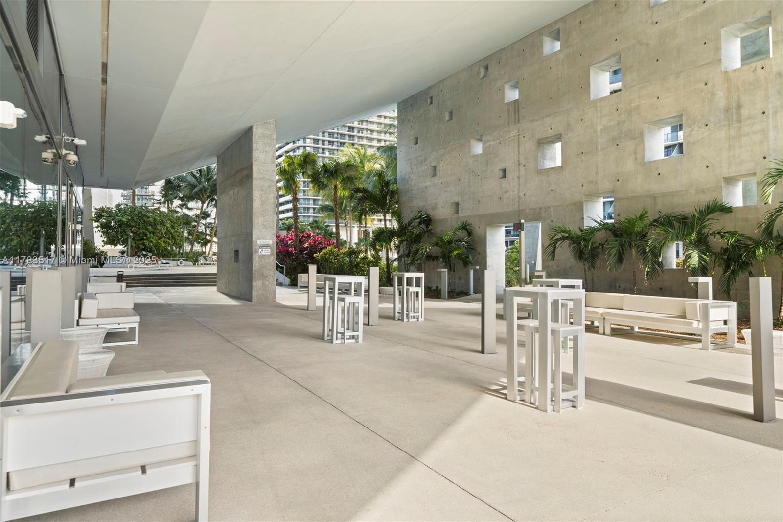 88 Southwest 7th Street, Unit 809 Miami, FL 33130 - Photo 35 of 45 a view of a patio with a table and chairs and potted plants