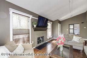 21 Maple Lane, Unit B Brielle, NJ 08730 - Photo 12 of 51 a living room with furniture wooden floor and a fireplace