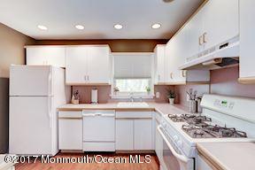 21 Maple Lane, Unit B Brielle, NJ 08730 - Photo 17 of 51 a kitchen with a sink a stove a refrigerator and white cabinets