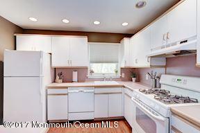 21 Maple Lane, Unit B Brielle, NJ 08730 - Photo 18 of 51 a kitchen with a sink a stove a refrigerator and cabinets