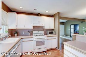 21 Maple Lane, Unit B Brielle, NJ 08730 - Photo 20 of 51 a kitchen with kitchen island a stove a sink and a refrigerator