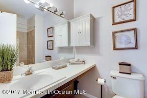 21 Maple Lane, Unit B Brielle, NJ 08730 - Photo 26 of 51 a bathroom with a sink a mirror and a toilet