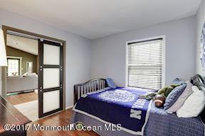 21 Maple Lane, Unit B Brielle, NJ 08730 - Photo 28 of 51 a bedroom with a bed and window