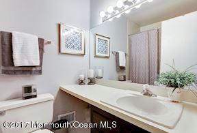 21 Maple Lane, Unit B Brielle, NJ 08730 - Photo 30 of 51 a bathroom with a sink and a mirror