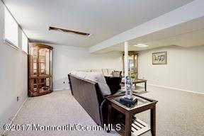21 Maple Lane, Unit B Brielle, NJ 08730 - Photo 33 of 51 a living room with furniture a window and a flat screen tv