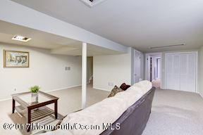 21 Maple Lane, Unit B Brielle, NJ 08730 - Photo 35 of 51 a living room with a couch and a potted plant