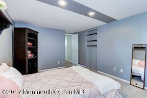 21 Maple Lane, Unit B Brielle, NJ 08730 - Photo 38 of 51 a bedroom with a bed and a television