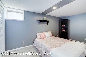 21 Maple Lane, Unit B Brielle, NJ 08730 - Photo 39 of 51 a bedroom with a bed and a night stand