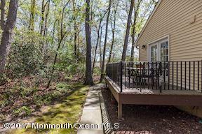 21 Maple Lane, Unit B Brielle, NJ 08730 - Photo 48 of 51 a view of a bench in a backyard