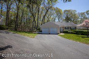 21 Maple Lane, Unit B Brielle, NJ 08730 - Photo 8 of 51 a front view of a house with a yard and garage