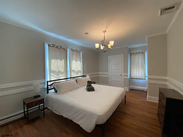 a bedroom with a bed and a chandelier