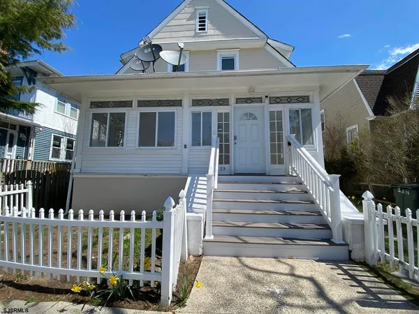 a front view of a house with wooden fence
