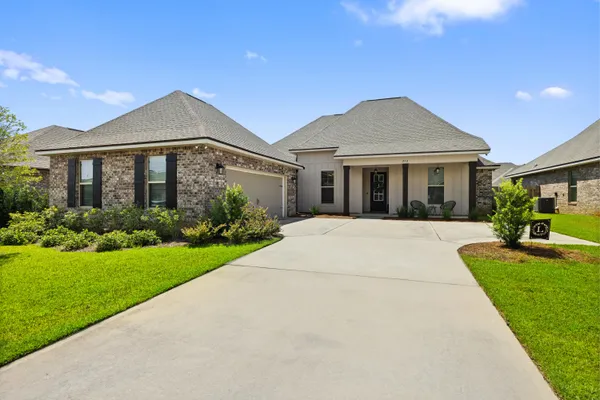 a front view of house with yard and green space