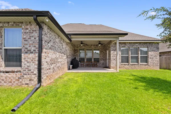 a view of a balcony with chairs and a potted plant