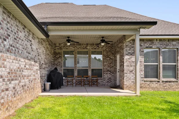 a living room with furniture ceiling fan and a wooden floor