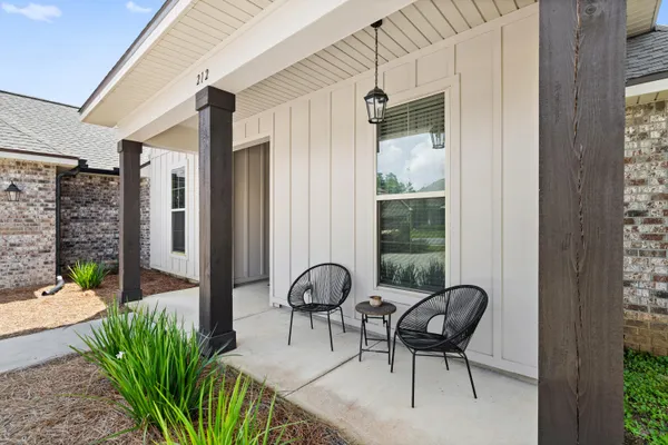 a living room with furniture a flat screen tv and a dining table