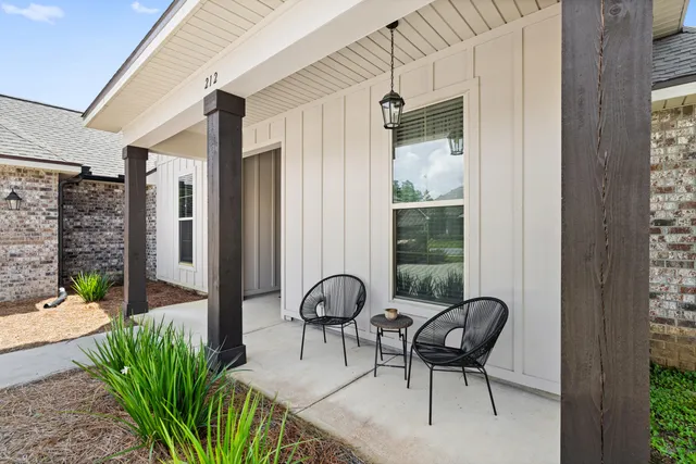 a living room with furniture a flat screen tv and a dining table