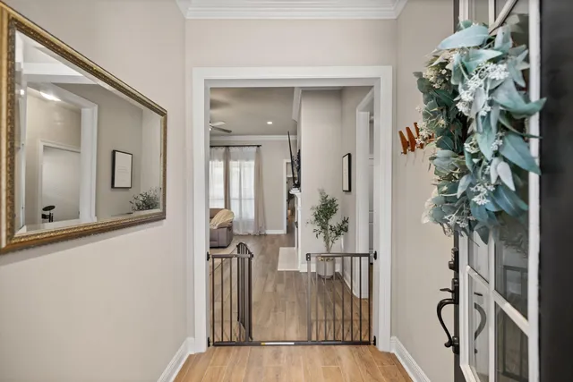 a kitchen with refrigerator a sink and wooden floor