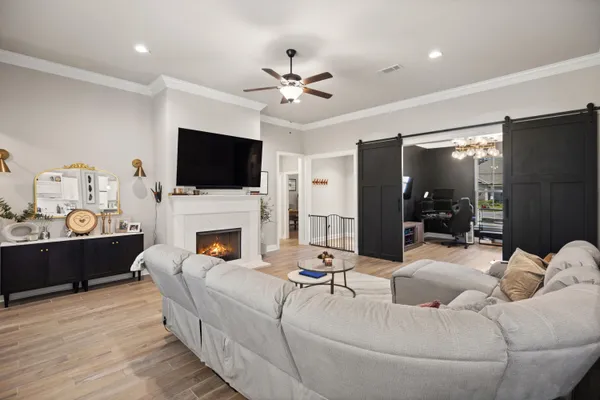 a living room with kitchen island furniture and a chandelier