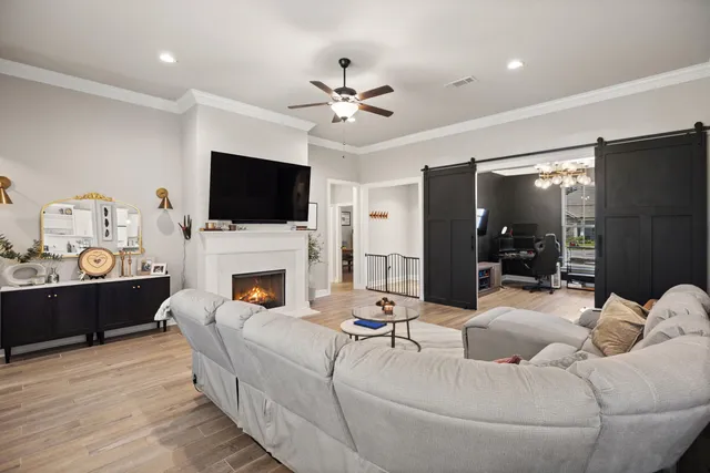 a living room with kitchen island furniture and a chandelier