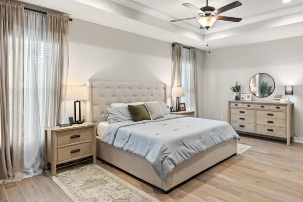 a bedroom with a bed a flat screen tv and a dining table