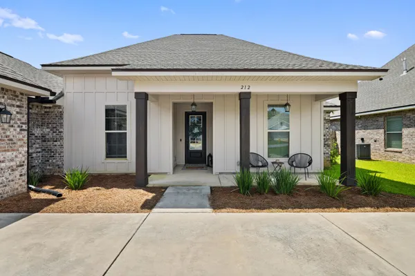 a aerial view of a house with a yard and lake view