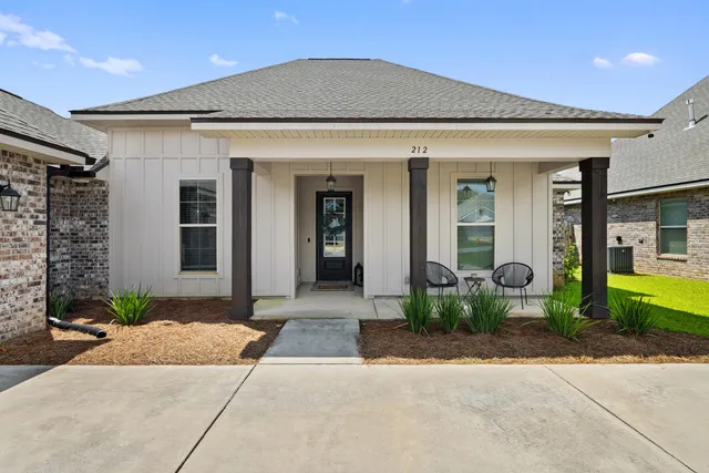 a aerial view of a house with a yard and lake view