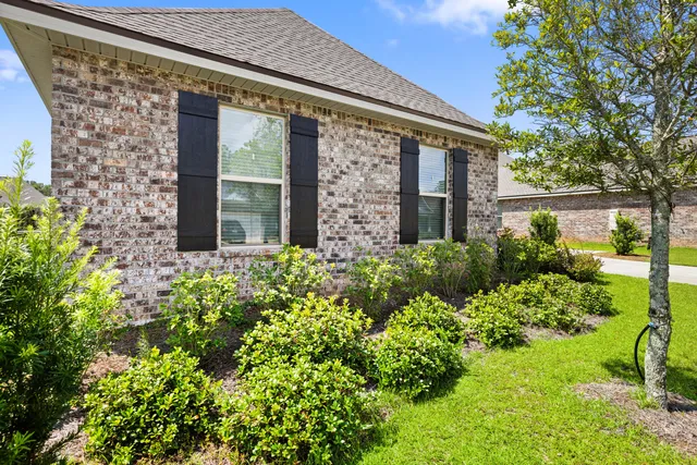 a front view of house with backyard and green space