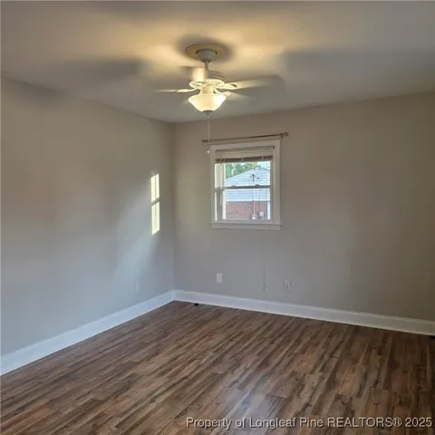 a view of a room with wooden floor and chandelier