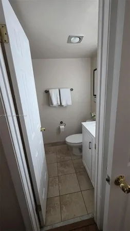 a bathroom with a granite countertop sink a mirror and a bathtub