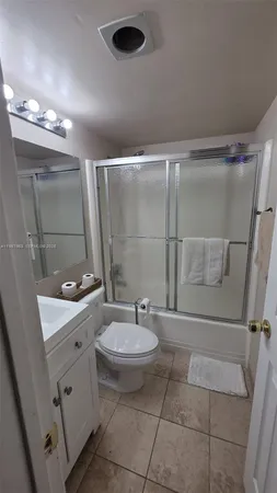 a view of a balcony with chairs and a potted plant