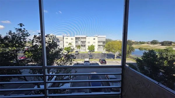 a view of a yard with plants and trees
