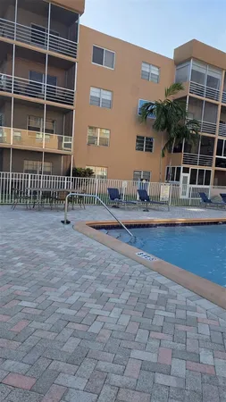 a view of a balcony with two chairs and a potted plant