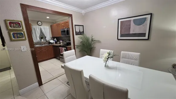 a dining room with a white table and chairs