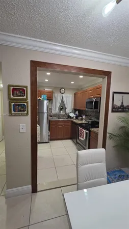 a large kitchen with kitchen island granite countertop a refrigerator and a sink
