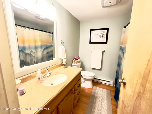 a bathroom with a sink mirror bathtub and toilet