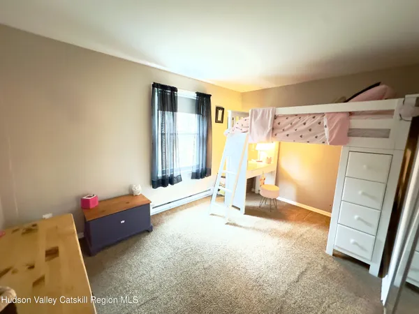 a living room with a couch and a dresser