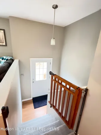 a view of a hallway with stairs and a window