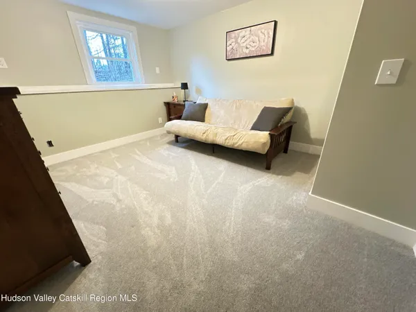 a living room with furniture and a wall