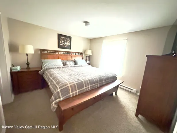 a bedroom with a bed and a night stand