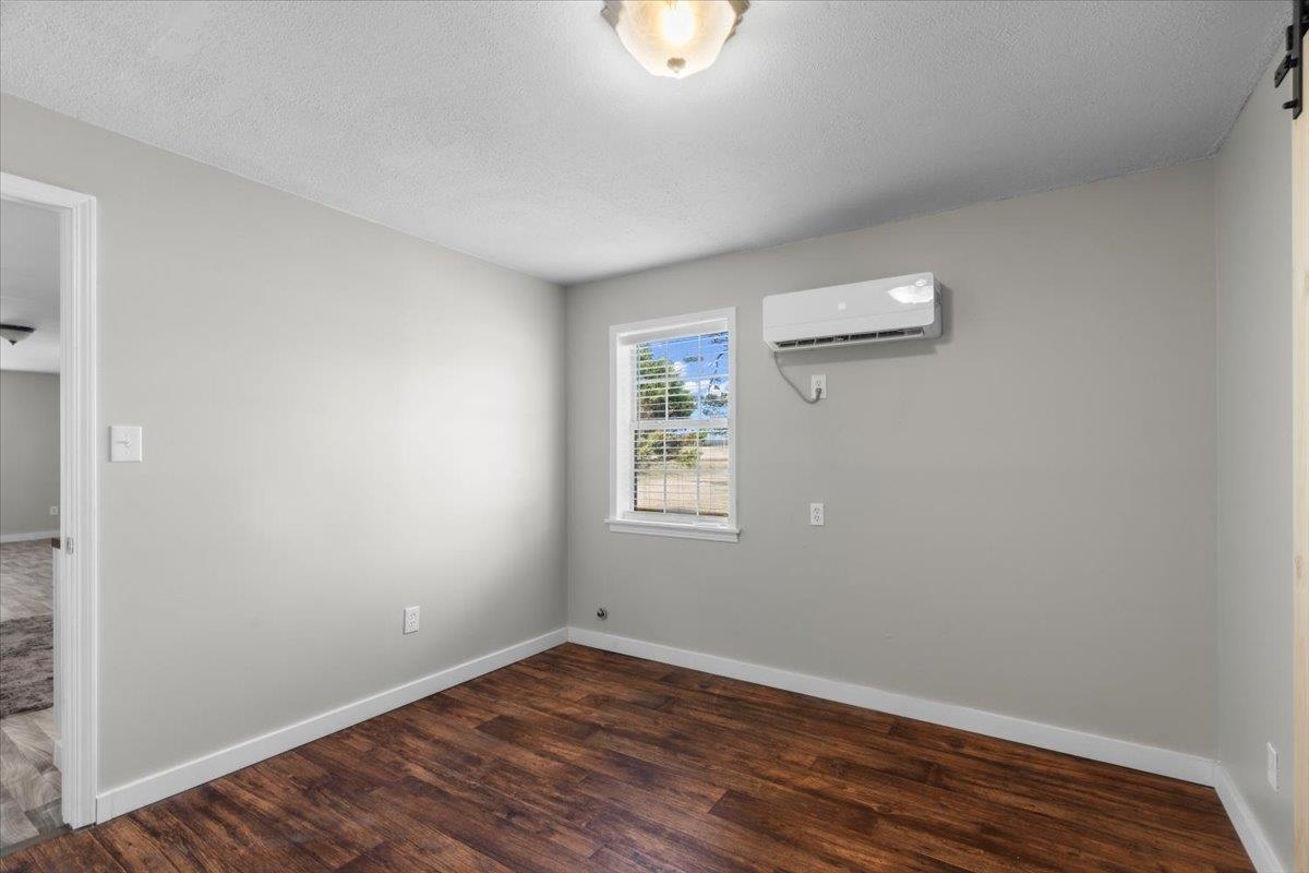 2030 South Main Street Covington, TN 38019 - Photo 11 of 27 a view of an empty room with wooden floor and a window