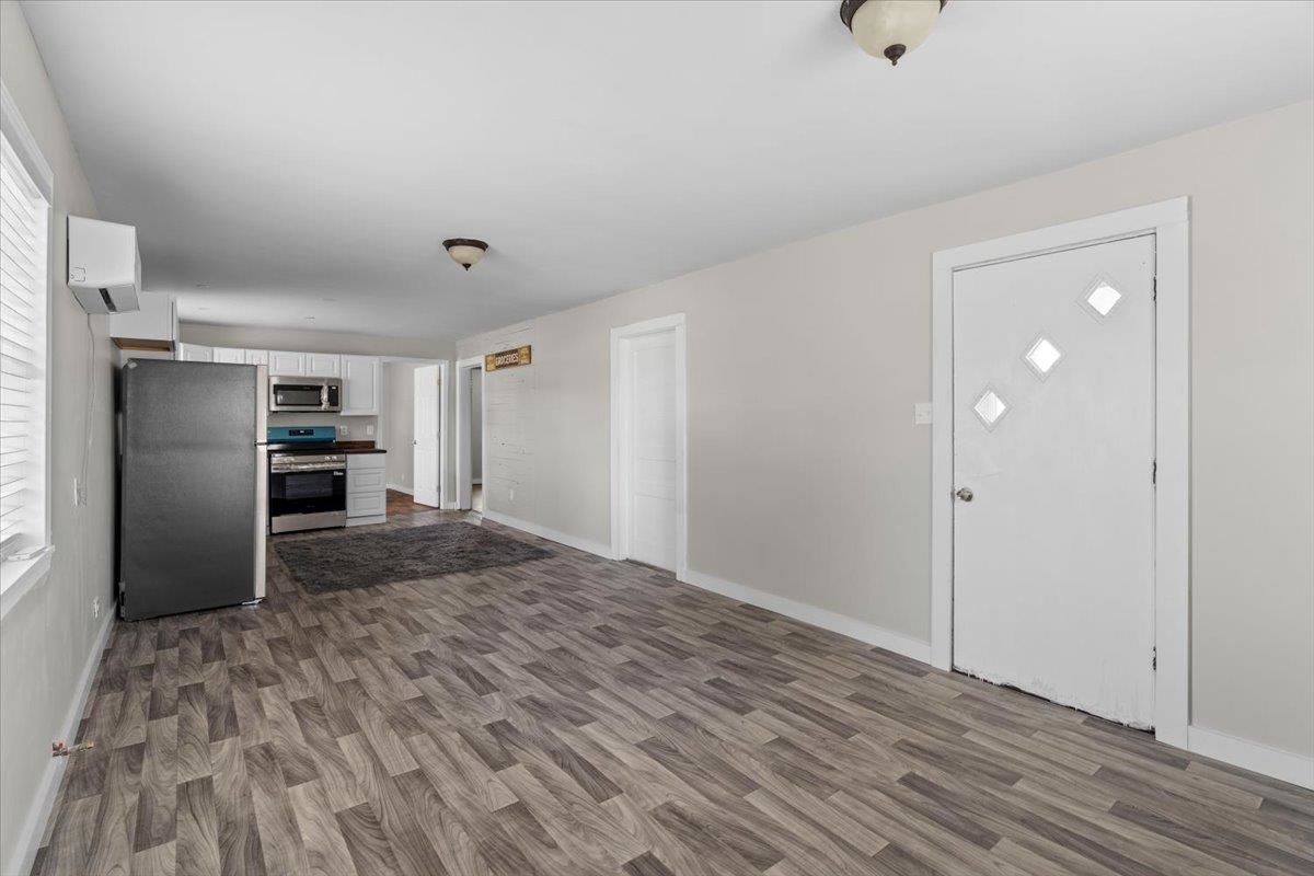 2030 South Main Street Covington, TN 38019 - Photo 6 of 27 a view of a kitchen with wooden floor and a refrigerator